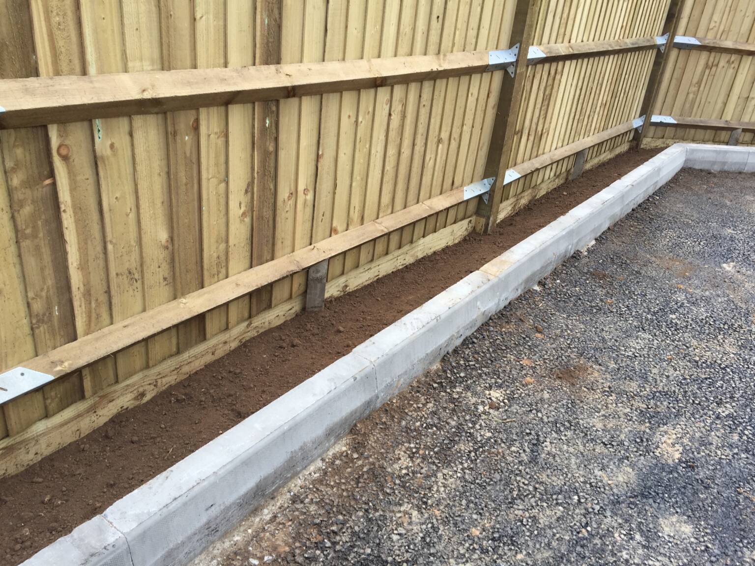 Hardscaping 4 Wooden fence next to a driveway