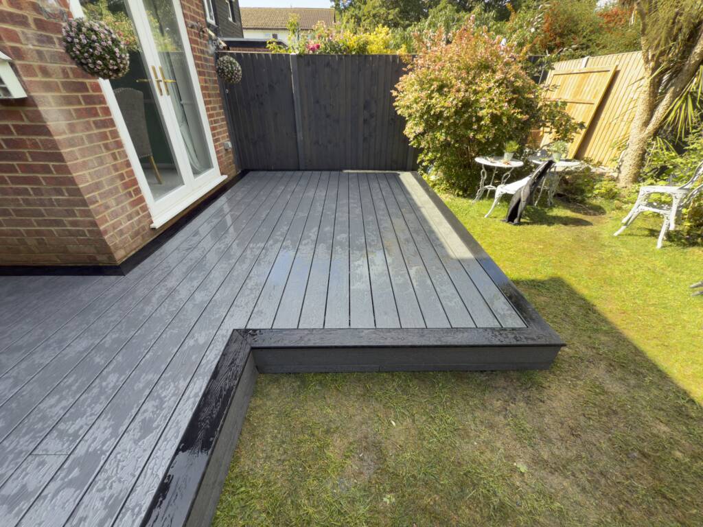 Composite vs. Timber Decking: Which is Best for Your Surrey Garden? 1 Composite decking in the rear garden of a house in Surrey